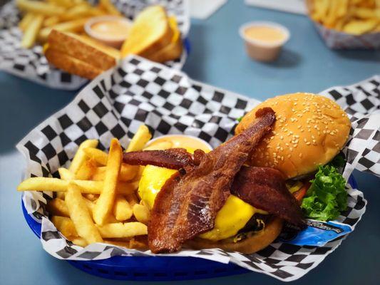 Deluxe burger with bacon and French fries