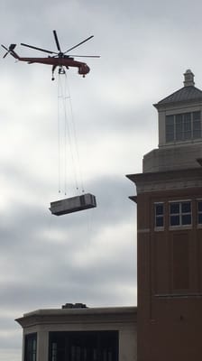 Air conditioning unit being delivered to roof top