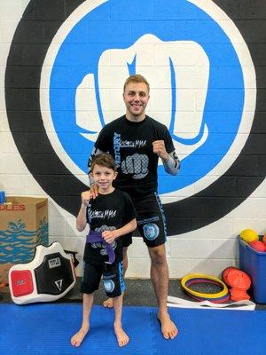 My son with Sensei Alex after being awarded his purple belt.