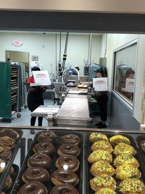 Glazing and boxing up hot donuts