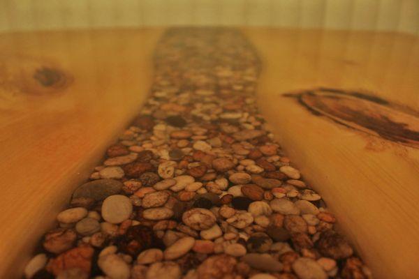 River rock epoxy table mounted on a pallet bar-top with shelves and swivel stools. Functional and beautiful