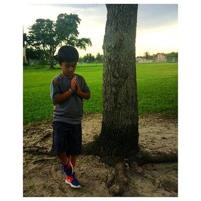 My son practicing yoga on his own in that great green open space in Rockway Park.