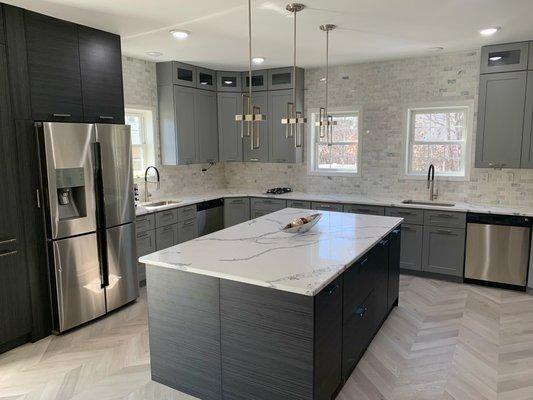 Kitchen remodel gray shaker with dark gray island & pantry, chevron flooring, quartz countertop