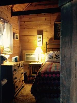 The bedroom was cozy with warm, soft lighting.  Comfortable quilts and bedding.