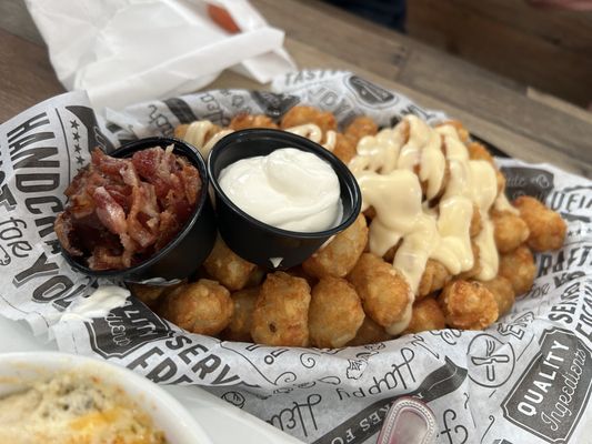 Loaded tater tots ( we got the bacon and sour cream on the side). Always a hit!