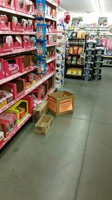 Box of candy with sign on floor