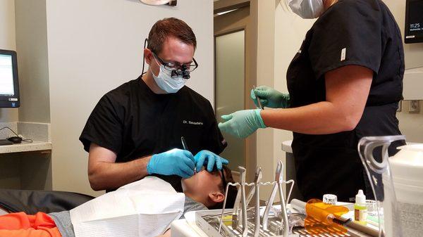 Pictured here is Dr. Savastano and our orthodontic assistant, Cheri working hands on with our patient.