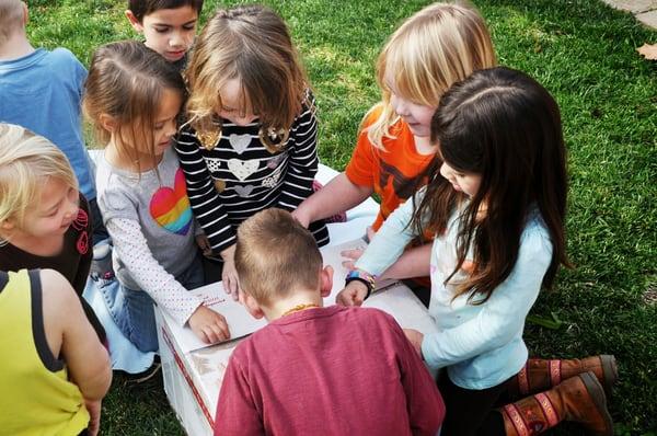 Children from CPCC opening a special gift from Scholastic books