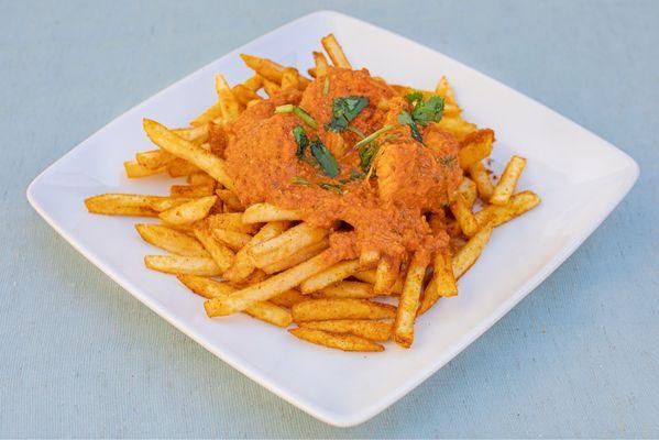 Our famous Butter Chicken over our Masala Fries