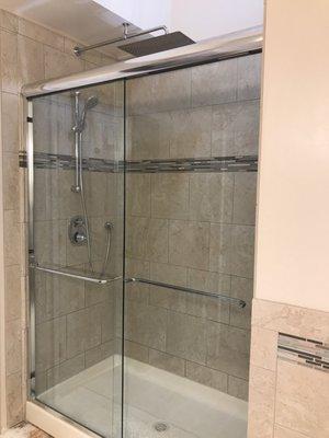 New shower with a custom designed wall & interior bench seat.