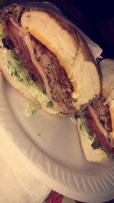 The classy Dinasia ! Honey turkey , Bacon, American and Swiss , grilled onions and peppers, lettuce, tomatoes, extra mayo !