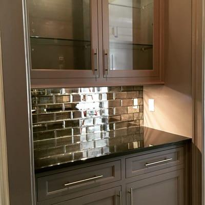 Absolute Black granite bar with black glass mirrored tile.