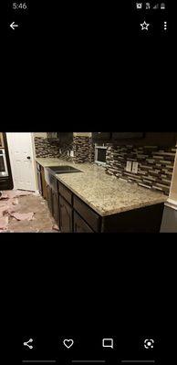 Santa Cecilia granite Countertops with stainless steel farmer sink with backsplash