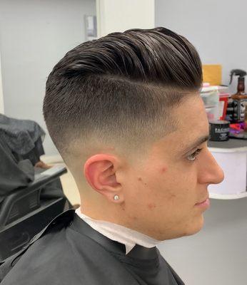 Skin fade with a push back hair style pompadour look