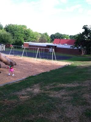 Back of building and playground.