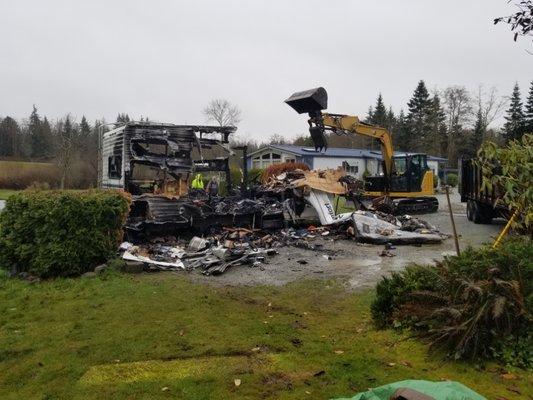 Demolition of a burnt 5th wheel travel trailer