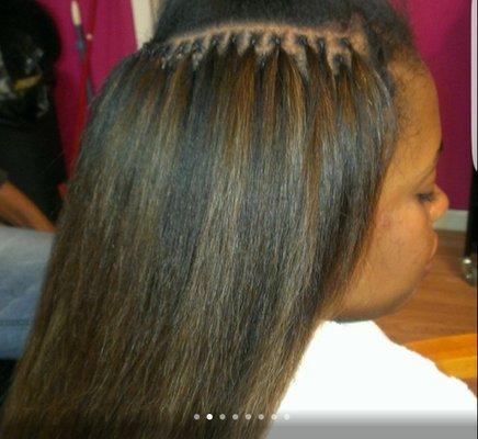 Brazilian knot extensions.  strand by strand method applied by a using a stretch like string. Can be worn in a high ponytail