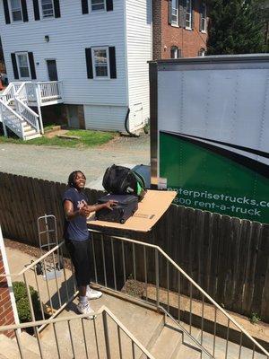 Ingenious way of using truck lift over the fence and a bed-frame to slide stuff to the first floor balcony. Saved a long walk and lifting!