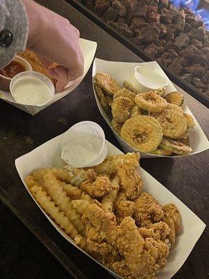 Fried Pickle Chips, Jesus Nuggets w/ Fries, Mozzarella Sticks (being grabbed)