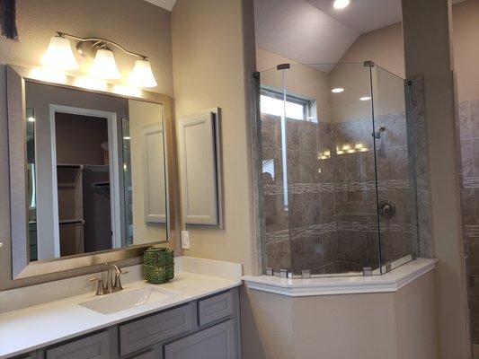 Framed mirror and frameless shower