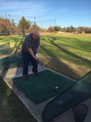 Rubber tees and my dad ready to swing.