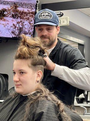 Cleaning up her shaved undercut.