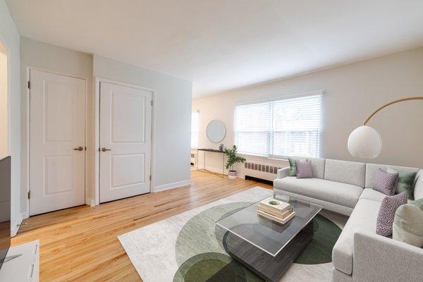 Spacious living room with original hardwood floors.