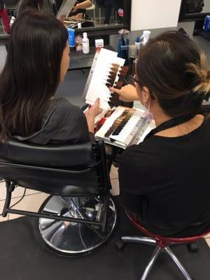 Sarah consulting with her client about hair color before working her magic!