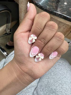 Pink French tip nails with pearls and mini bows :) almond shaped 75$