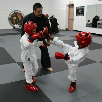 Kids learning how to spar to better prepare them for a real self-defense situation.