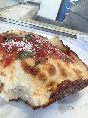 Detroit style pizza with fresh tomato sauce and basil