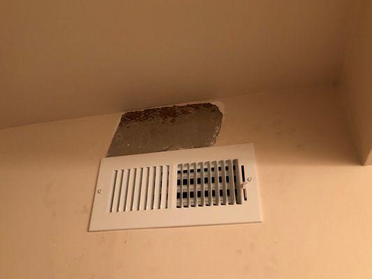 Broken plaster from vent install, never repaired by installers