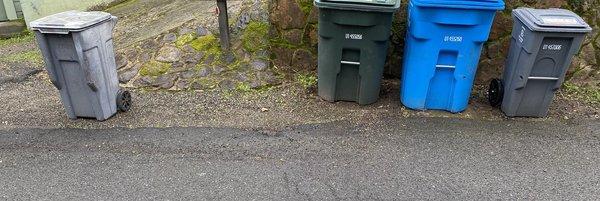 Full garbage can missed/ignored by inattentive garbage truck driver