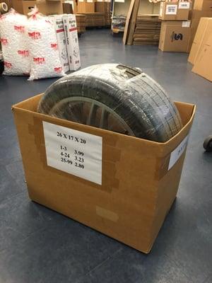 Prepping professional packaging of a Ferrari F430 wheel set.