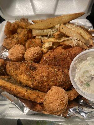 Fish dinner fries coleslaw and hush puppies