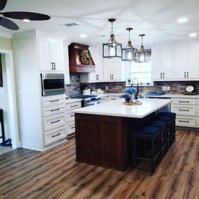 A beautiful kitchen with custom quartz countertops and island.. Can we say Home Sweet Home!!!!