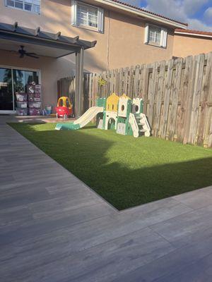 Outdoor tile and standard synthetic grass by design.