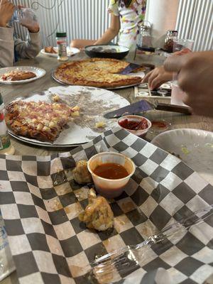 Naked wings, Hawaiian pizza, cheese pizza and Greek salad