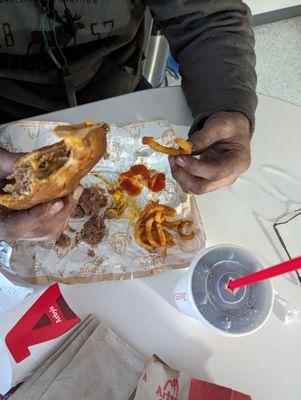 Arby's roast beef and cheese, curly fries and a medium coke