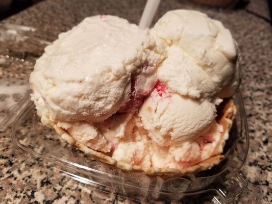 Coconut, Strawberry Cheesecake, and Strawberries and Cream ice cream in a waffle cone bowl.