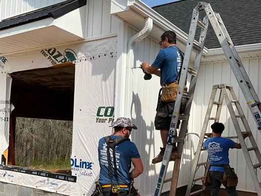 The Concord Gutter Service team installing new seamless gutter