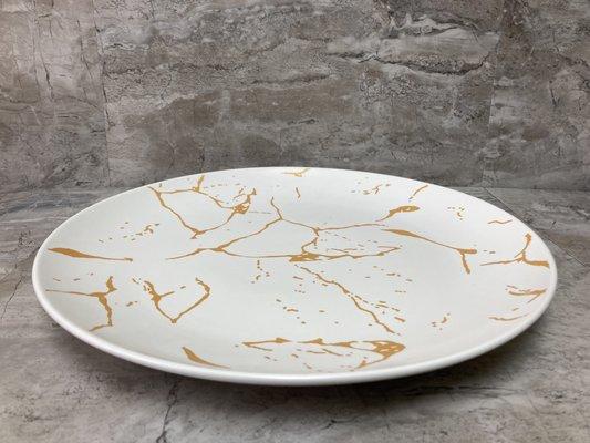 Round marble pattern gold color serving dish.