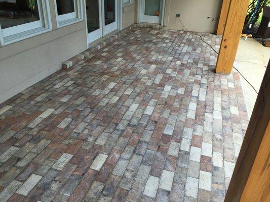 Back patio with porcelain paver tile installed.