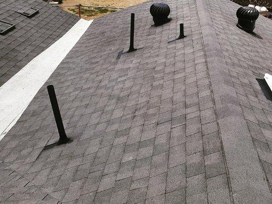 A shingle roof we replaced with a unique transition that was deftly handled by one of our roofing crews.