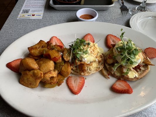 Lobster Eggs Benedict and home fries with peppers.