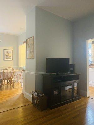 A view from the living room couch towards the dining room and kitchen.