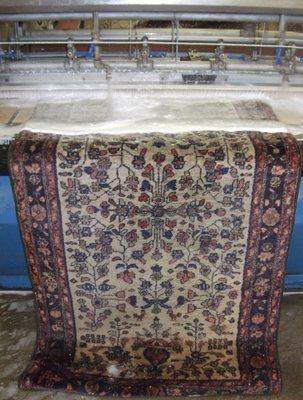 Pictured is a handmade rug passing through our world famous MOR Rug Cleaning Machine!