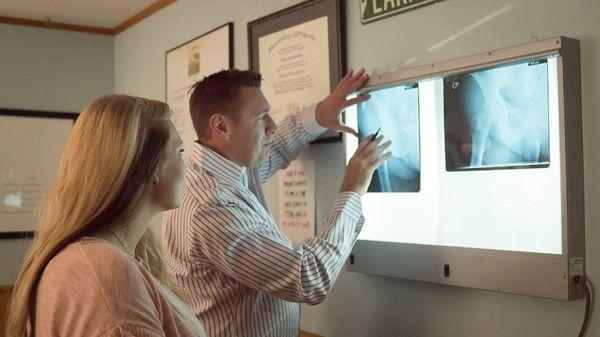 Dr. Steve Van Osdale examining x-rays with a patient