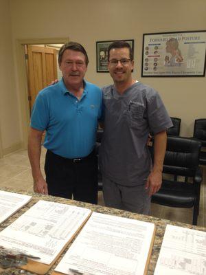 Dr. Henry with his first patient in the new office. We are happy to help you.