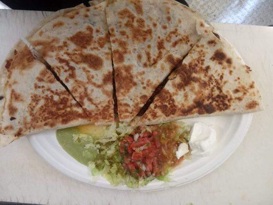 Super quesadilla with lettuce ,pico de gallo, sourcream ,guacamole,red and green salsa.